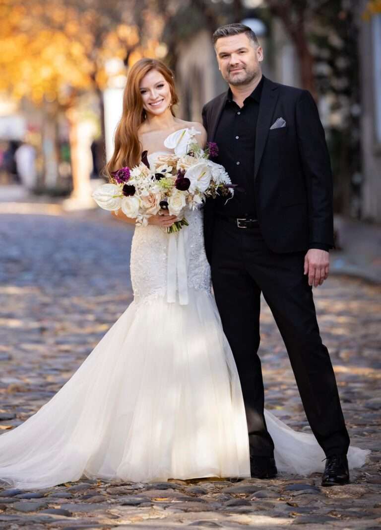 Groom in custom J.Hilburn suit styled by Denise McBride, celebrating his wedding day with his bride—tailored for a flawless fit in Minneapolis–St. Paul.